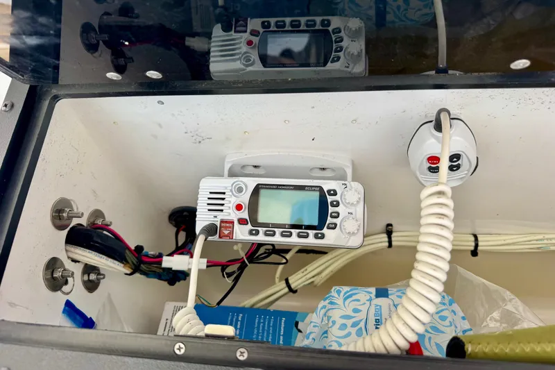 Slide: The Image of Radio equipment inside a 2017 Blazer Bay 2400 boat compartment. - 14