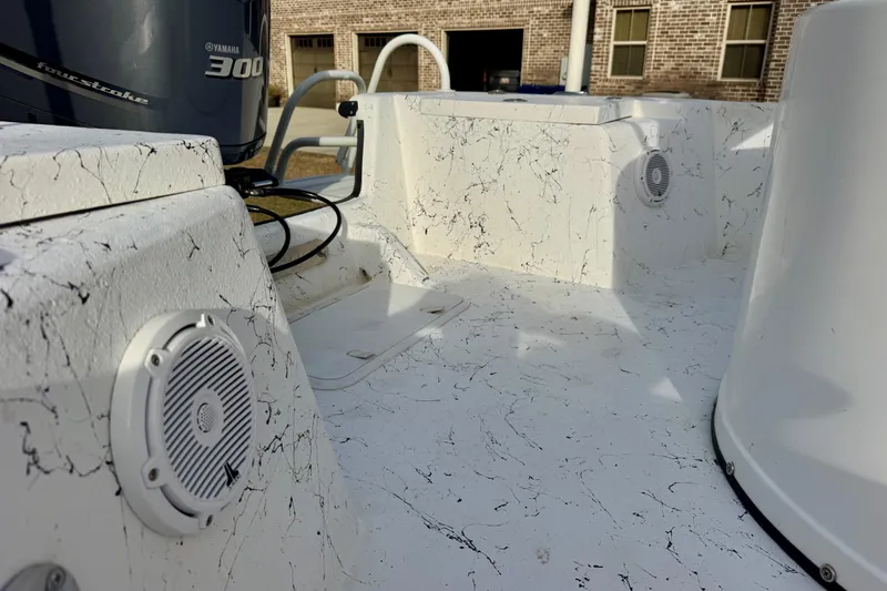 Slide: The Image of 2017 Blazer Bay 2400 boat interior with Yamaha 300 engine, featuring speakers and textured surfaces. - 15