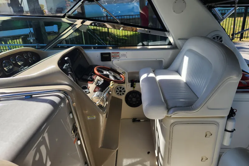 Slide: The Image of 2001 Sea Ray 340 Amberjack helm with white seating and steering wheel. - 12