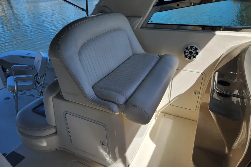 Slide: The Image of 2001 Sea Ray 340 Amberjack interior with cushioned seating and water view. - 16