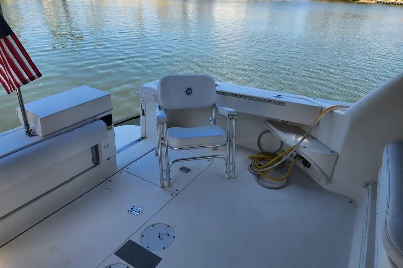 Slide: The Image of 2001 Sea Ray 340 Amberjack boat deck with chair and American flag. - 24