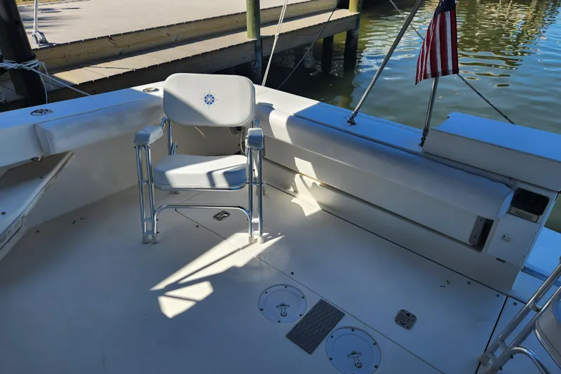 Slide: The Image of 2001 Sea Ray 340 Amberjack boat deck with chair and American flag. - 25