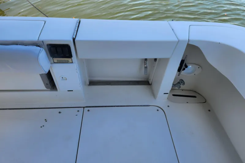 Slide: The Image of 2001 Sea Ray 340 Amberjack boat deck with seating and control panel by the water. - 28