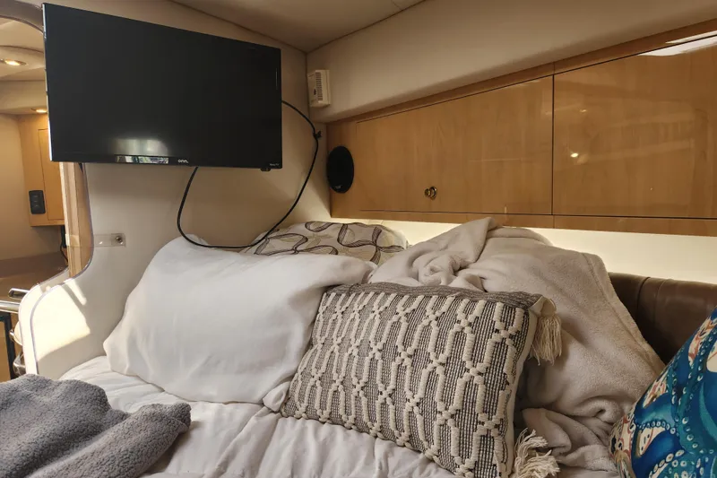 Slide: The Image of Cozy cabin interior of 2001 Sea Ray 340 Amberjack with TV and plush bedding. - 32