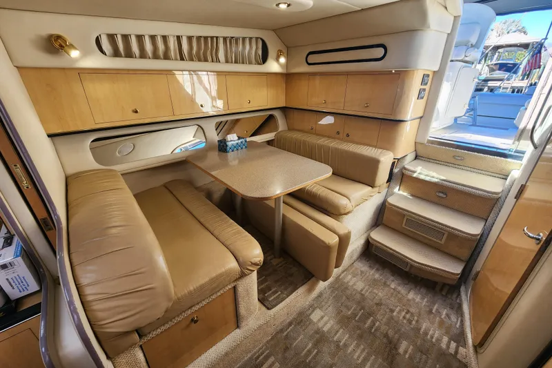 Slide: The Image of Luxurious interior of 2001 Sea Ray 340 Amberjack yacht with beige seating and wooden cabinetry. - 34