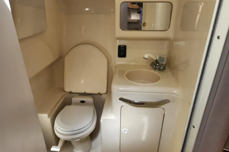 Slide: The Image of 2001 Sea Ray 340 Amberjack bathroom with toilet, sink, and mirror. - 39