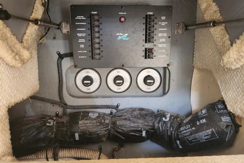 Slide: The Image of Electrical panel of a 2001 Sea Ray 340 Amberjack boat with control switches. - 41