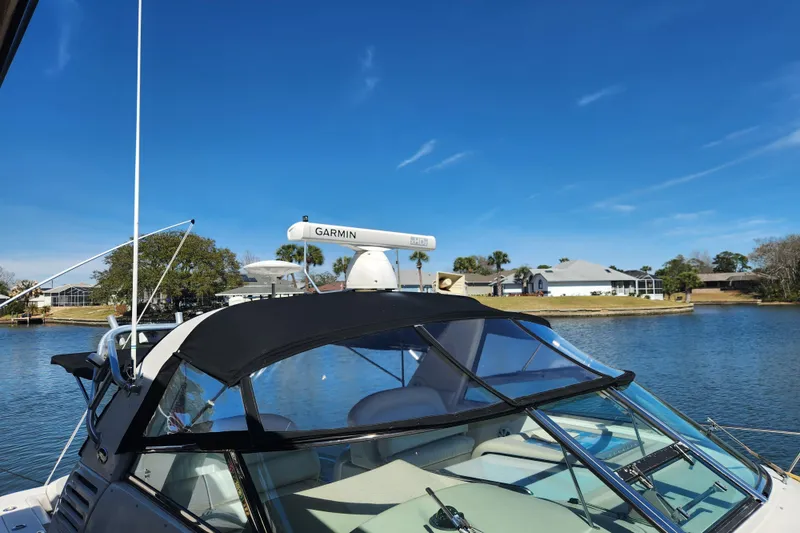 Slide: The Image of 2001 Sea Ray 340 Amberjack boat with Garmin radar on a sunny day by the water. - 5