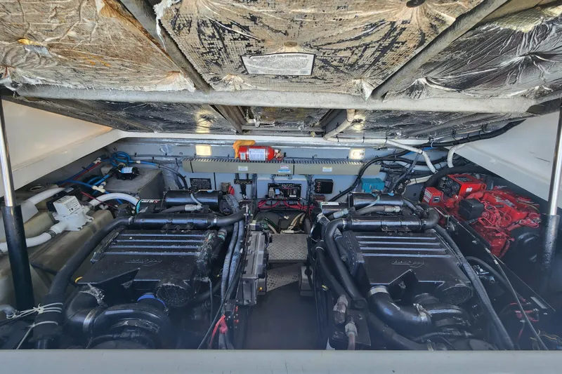 Slide: The Image of Engine room of a 2001 Sea Ray 340 Amberjack boat, showcasing dual engines and equipment. - 50
