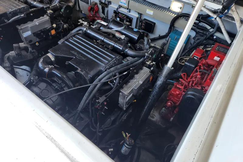 Slide: The Image of Engine compartment of a 2001 Sea Ray 340 Amberjack boat, showcasing mechanical components. - 52