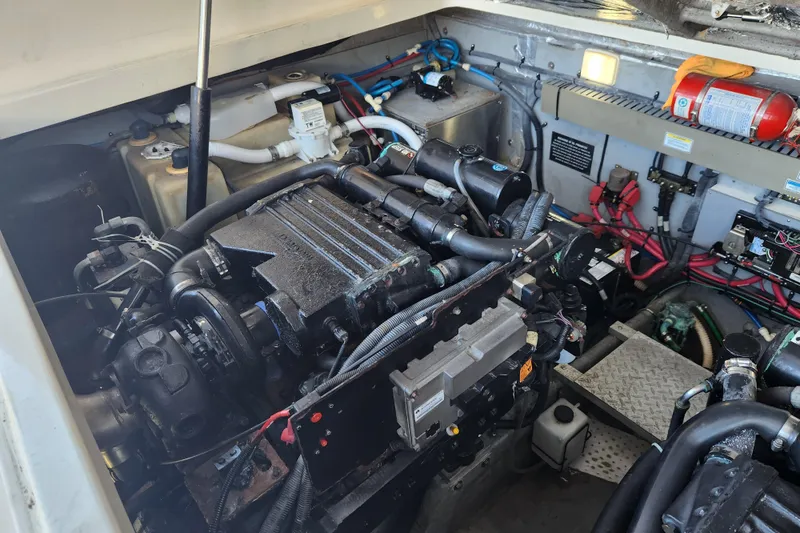 Slide: The Image of Engine compartment of a 2001 Sea Ray 340 Amberjack boat, showcasing mechanical components. - 54