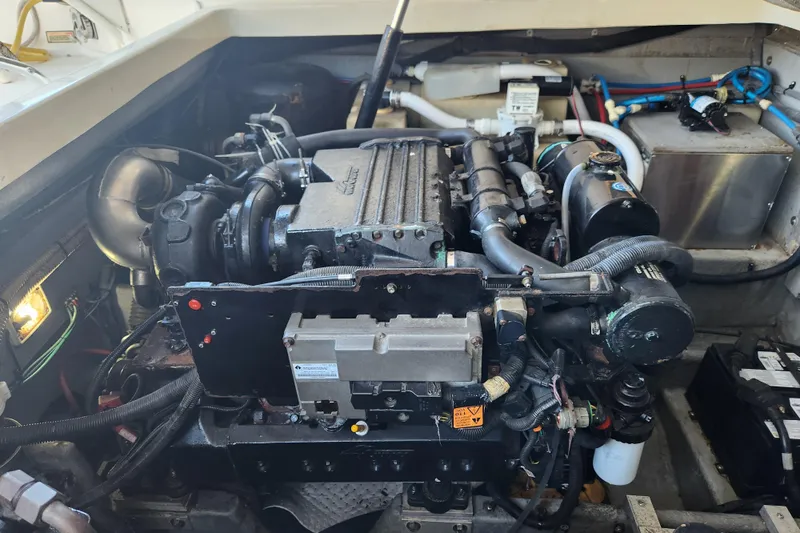 Slide: The Image of Engine compartment of a 2001 Sea Ray 340 Amberjack boat, showcasing detailed mechanical components. - 55