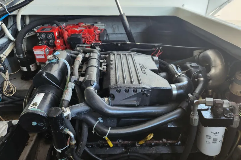 Slide: The Image of Engine compartment of a 2001 Sea Ray 340 Amberjack boat, showcasing detailed machinery. - 56