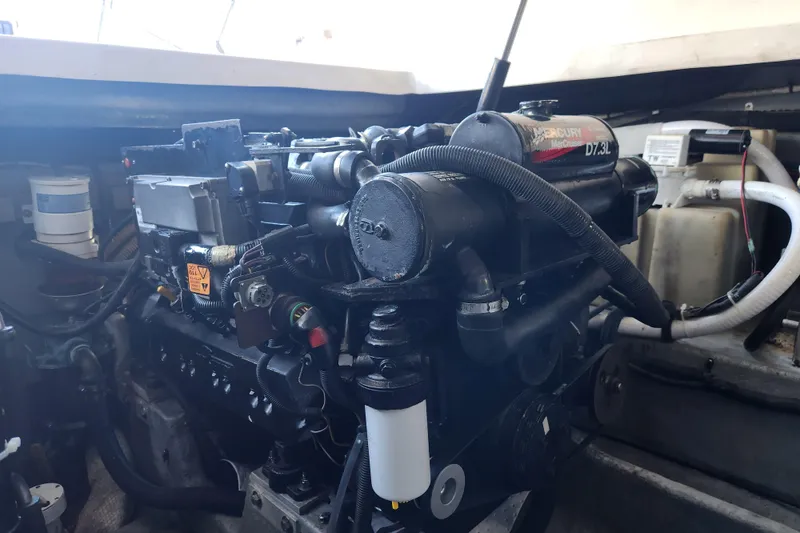 Slide: The Image of Engine compartment of 2001 Sea Ray 340 Amberjack boat, featuring a MerCruiser 7.3L engine. - 57
