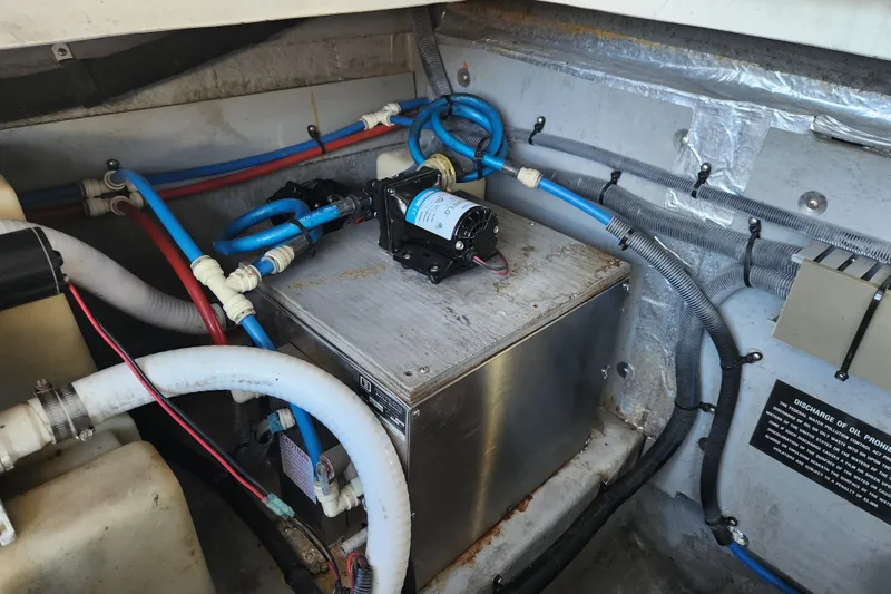 Slide: The Image of Engine compartment of a 2001 Sea Ray 340 Amberjack with visible wiring and components. - 61