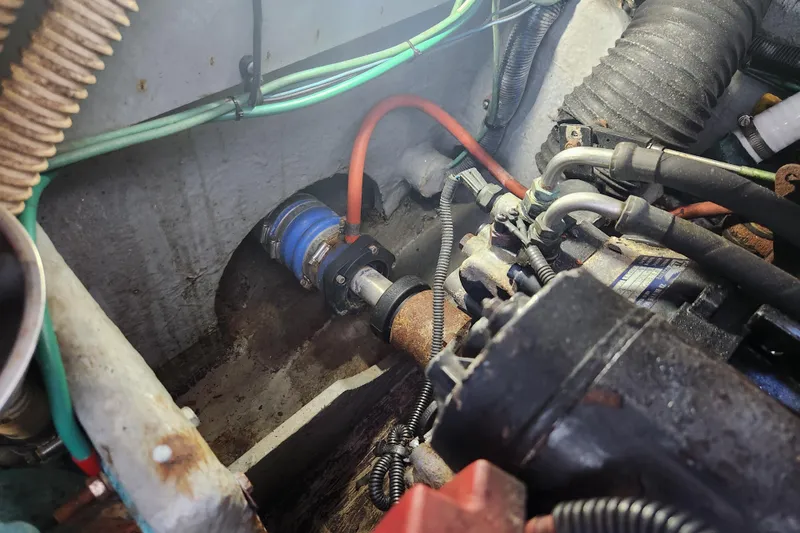 Slide: The Image of Engine compartment of a 2001 Sea Ray 340 Amberjack boat, showing hoses and mechanical components. - 63