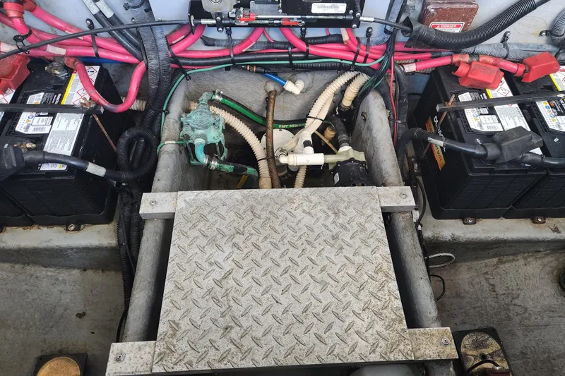 Slide: The Image of Engine compartment of a 2001 Sea Ray 340 Amberjack with batteries and wiring. - 64