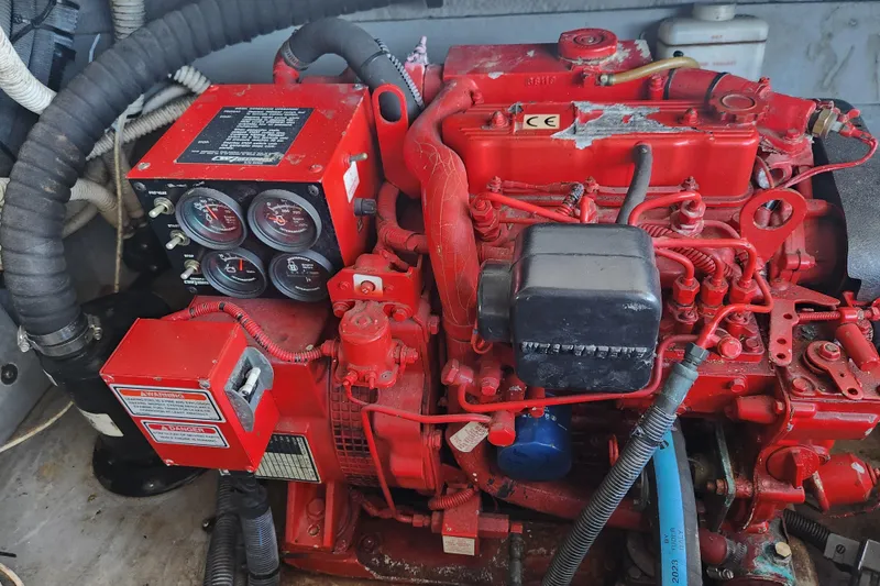Slide: The Image of Red engine of a 2001 Sea Ray 340 Amberjack boat, featuring gauges and wiring. - 65