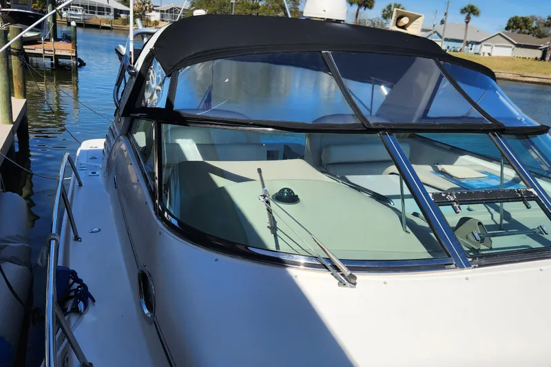 Slide: The Image of 2001 Sea Ray 340 Amberjack boat docked, featuring sleek design and spacious cockpit. - 9