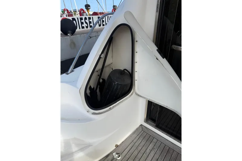 Slide: The Image of Open fender storage compartment on 2001 Sea Ray 560 Sedan Bridge yacht deck. - 11