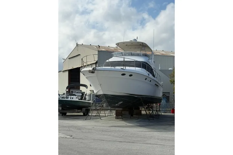 Slide: The Image of 2001 Sea Ray 560 Sedan Bridge yacht on dry dock. - 2