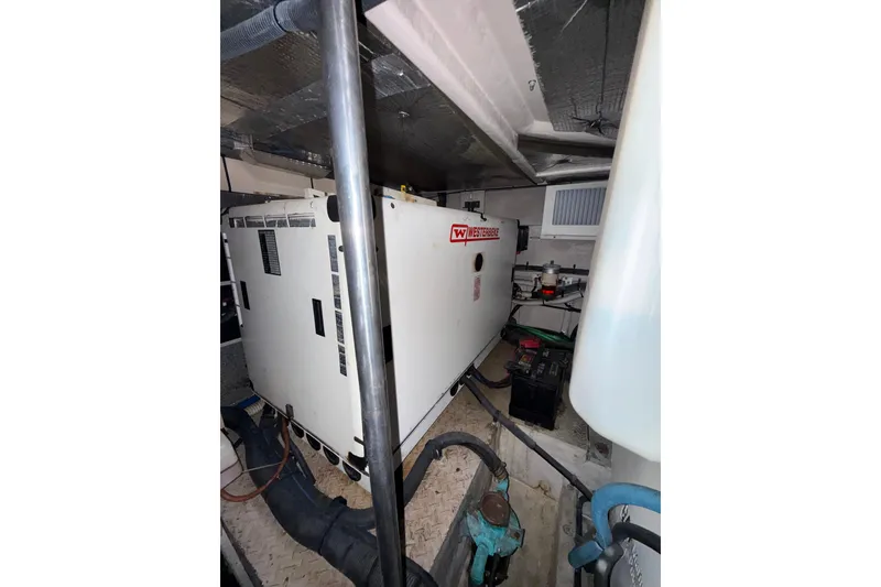 Slide: The Image of Engine room of 2001 Sea Ray 560 Sedan Bridge with control panels and equipment. - 28