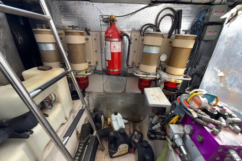 Slide: The Image of Engine room of 2001 Sea Ray 560 Sedan Bridge with visible machinery and equipment. - 32