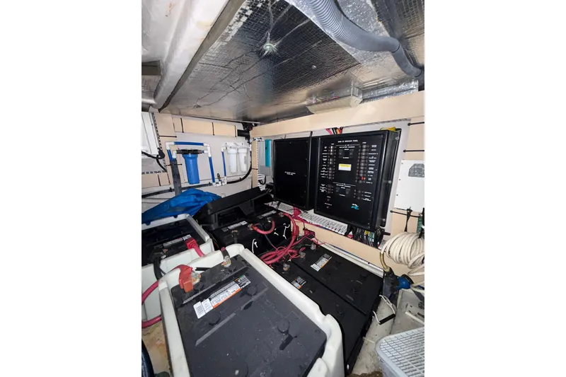 Slide: The Image of Engine room of a 2001 Sea Ray 560 Sedan Bridge, showing mechanical components and wiring. - 41