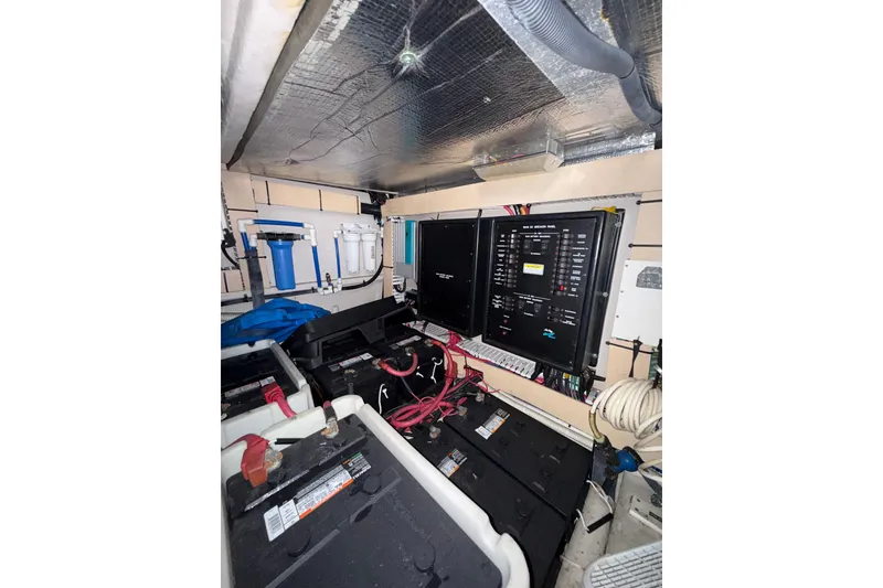 Slide: The Image of Engine room of 2001 Sea Ray 560 Sedan Bridge with electrical panels and batteries. - 42