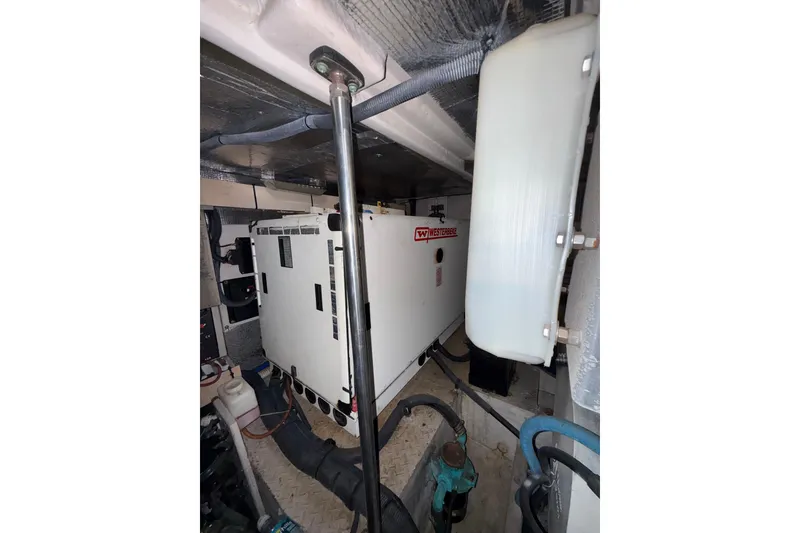 Slide: The Image of Engine room of 2001 Sea Ray 560 Sedan Bridge with batteries and control panels. - 46