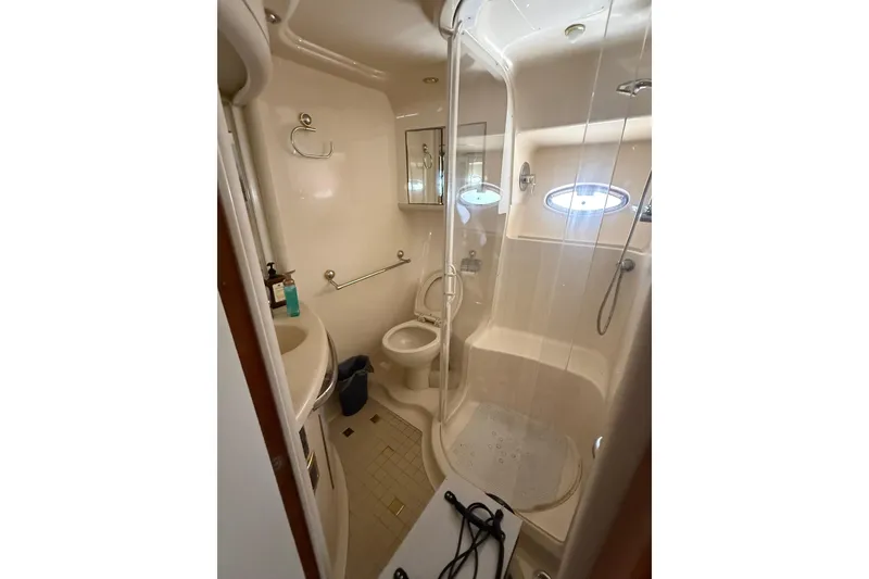 Slide: The Image of Bathroom interior of 2001 Sea Ray 560 Sedan Bridge yacht, featuring shower and vanity. - 49
