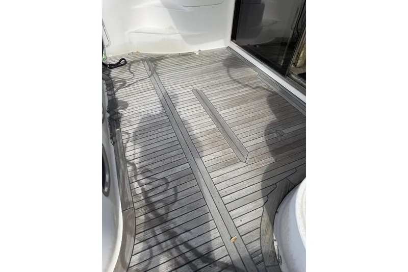 Slide: The Image of Teak deck of 2001 Sea Ray 560 Sedan Bridge yacht, showcasing wood finish. - 8