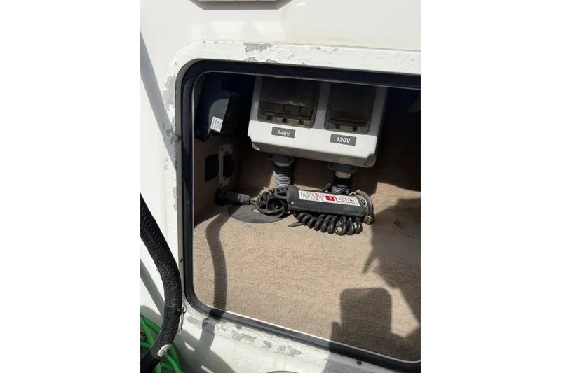 Slide: The Image of Electrical panel on a 2001 Sea Ray 560 Sedan Bridge yacht, showing 240V and 120V outlets. - 9