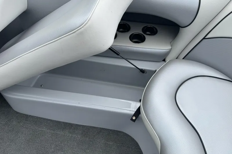 Slide: The Image of 2024 Sanger 215 S boat interior with gray seating and cup holders. - 13