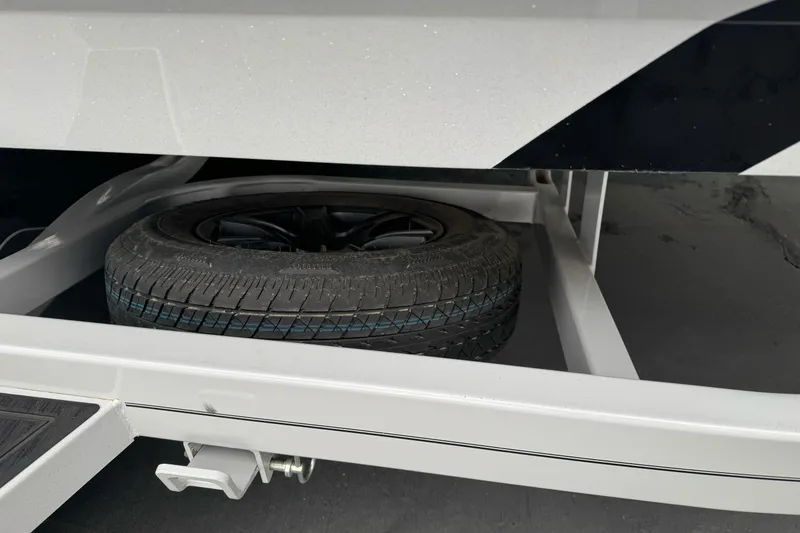 Slide: The Image of 2024 Sanger 215 S trailer with spare tire mounted underneath. - 6