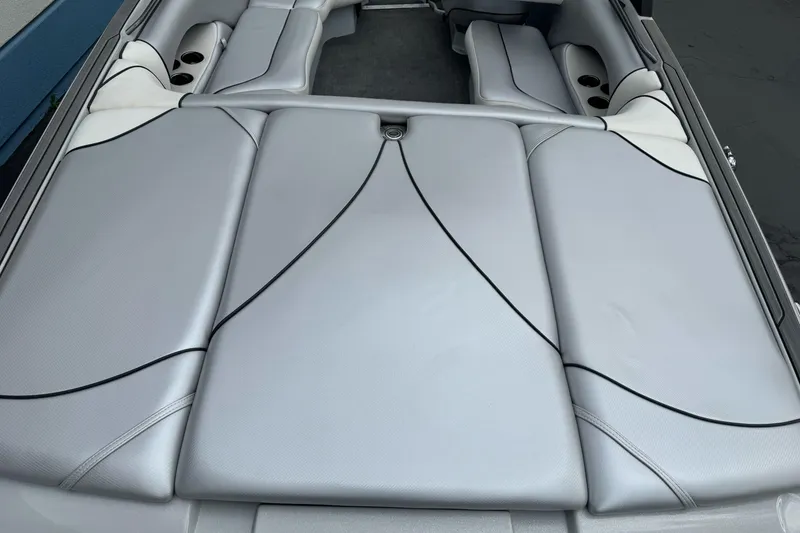 Slide: The Image of 2024 Sanger 215 S boat interior with sleek gray upholstery and cup holders. - 7