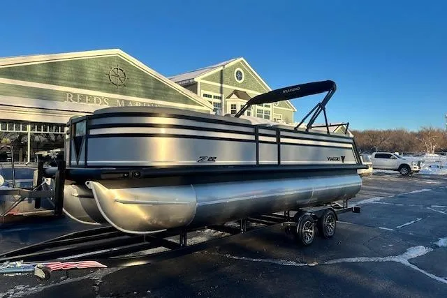 Slide: The Image of 2026 Viaggio Lago Z-B 22 pontoon boat on trailer at marina parking lot. - 0
