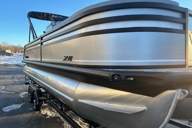 Slide: The Image of 2026 Viaggio Lago Z-B 22 pontoon boat on trailer, sleek silver design. - 2