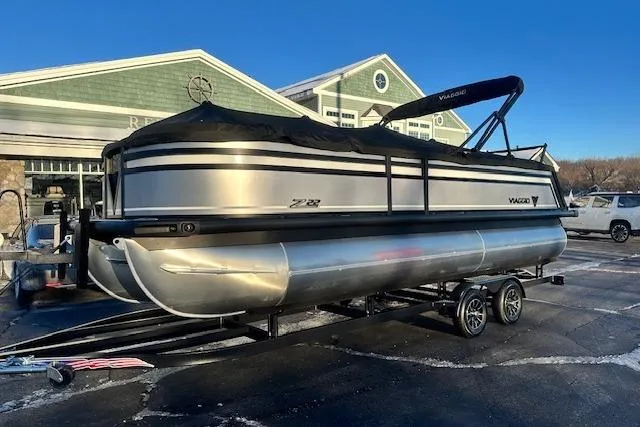 Slide: The Image of 2026 Viaggio Lago Z-B 22 pontoon boat on trailer, parked outside a building. - 37