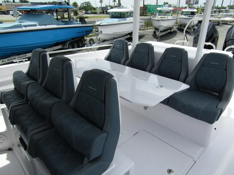 Slide: The Image of 2024 Axopar 37 Sun Top boat with sleek seating and modern design. - 14