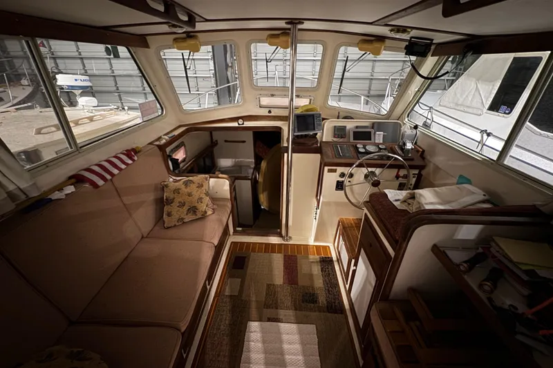 Slide: The Image of Interior of 1988 Blue Seas 31 boat with cozy seating and navigation area. - 10