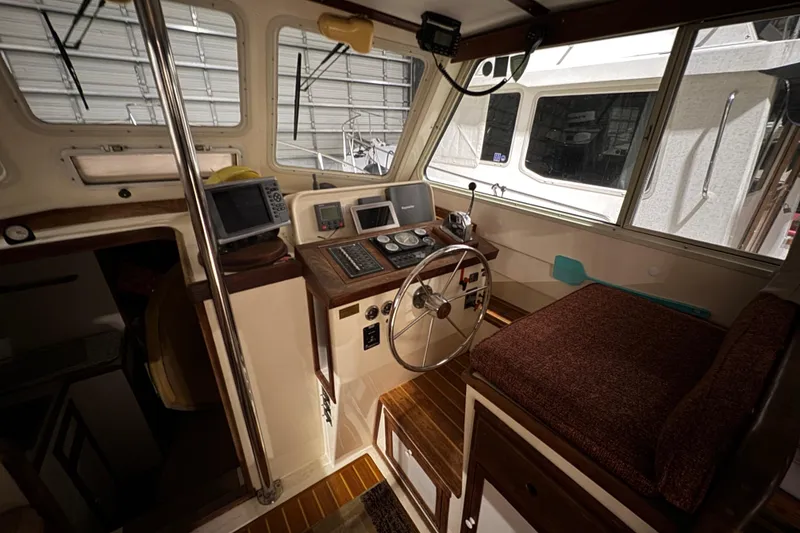 Slide: The Image of Interior of 1988 Blue Seas 31 boat with navigation equipment and steering wheel. - 13