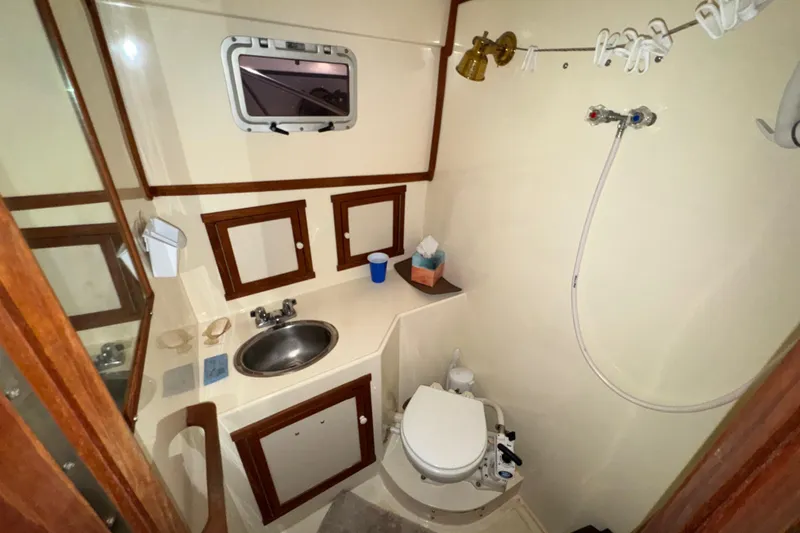 Slide: The Image of Compact bathroom in 1988 Blue Seas 31 boat with sink, toilet, and shower. - 21