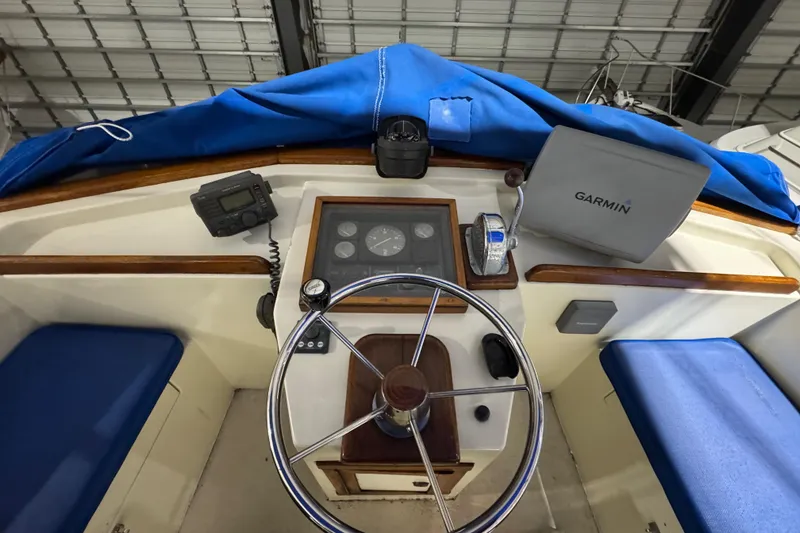 Slide: The Image of Cockpit of 1988 Blue Seas 31 boat with Garmin navigation system and steering wheel. - 23