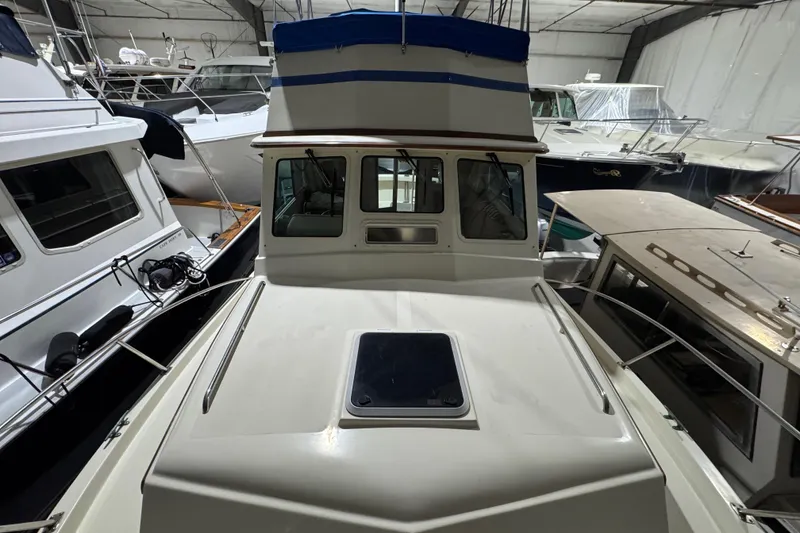 Slide: The Image of 1988 Blue Seas 31 boat in storage, surrounded by other vessels. - 25