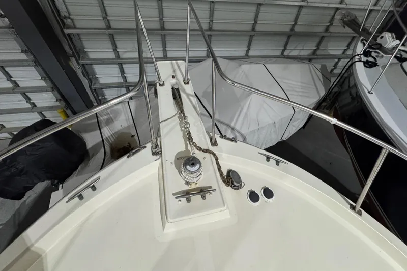 Slide: The Image of Bow of 1988 Blue Seas 31 boat in storage, featuring anchor chain and winch. - 26