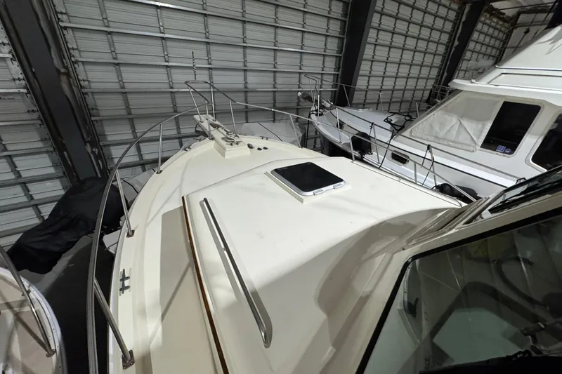 Slide: The Image of 1988 Blue Seas 31 boat in storage, showcasing deck and railings. - 27