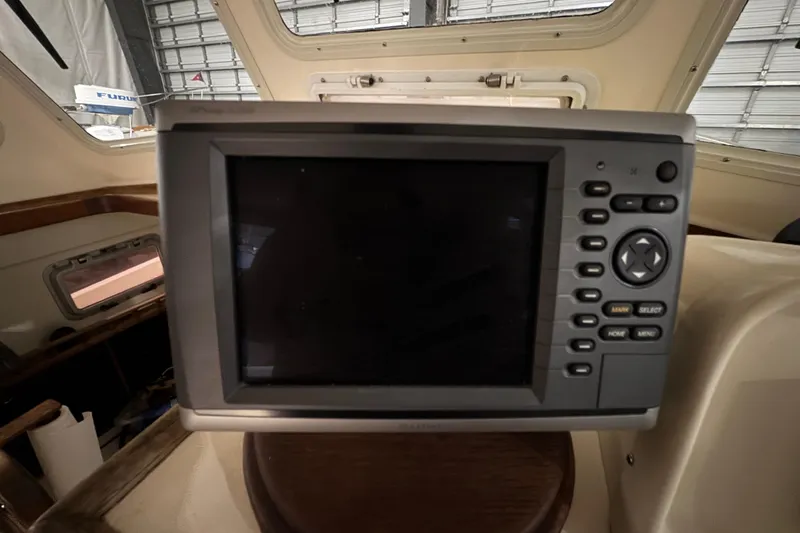 Slide: The Image of Navigation system inside 1988 Blue Seas 31 boat, featuring control buttons and display. - 28