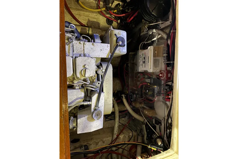 Slide: The Image of Engine compartment of a 1988 Blue Seas 31 boat, showing mechanical and electrical components. - 32