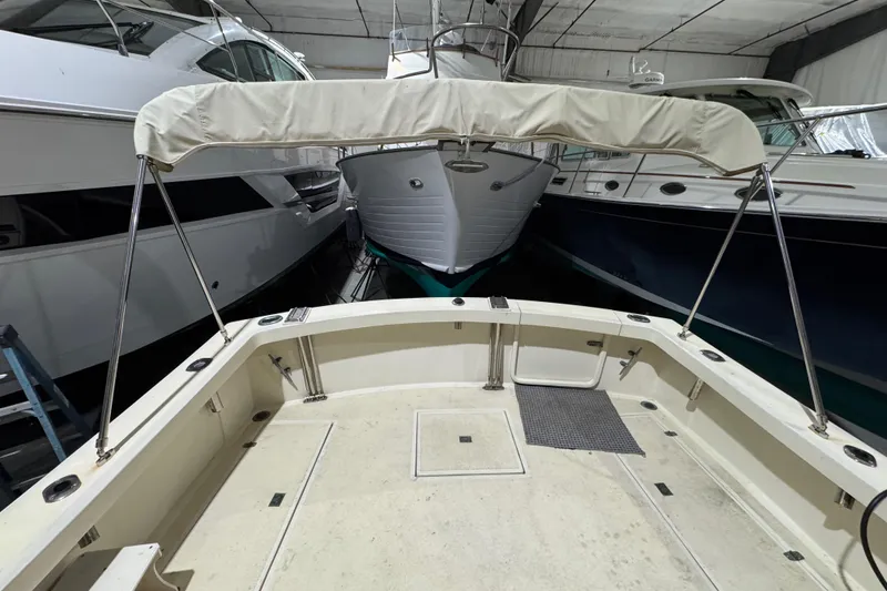 Slide: The Image of 1988 Blue Seas 31 boat in indoor storage, surrounded by other vessels. - 7